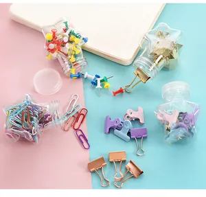 Macaron colored paper clips, binder clips and push pins in star shaped jars