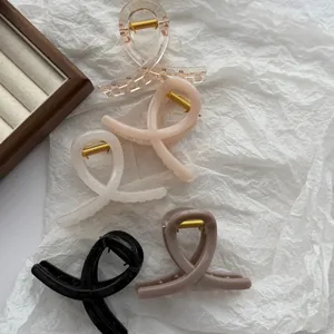 Set of 5 colorful jelly hair claw clips in various neutral tones on white paper backdrop.