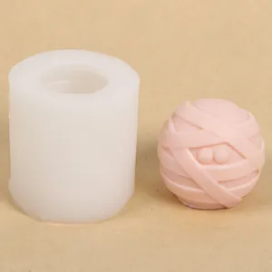 Close-up detail of a white silicone mold and a finished pink mummy bandage ball craft