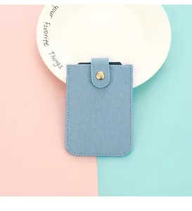 Light blue PU leather card holder featuring a denim texture and a bronze metal snap button