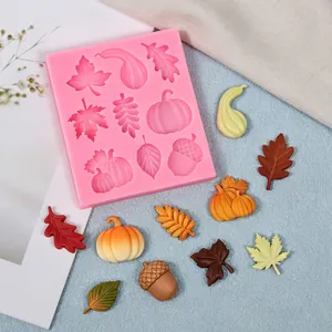 Autumn-themed pink silicone mold with pumpkin and leaf shapes for DIY cake decorating.