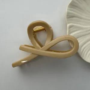 Detailed view of a large beige minimalist hair claw clip with a strong spring