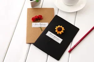 Handmade kraft paper greeting cards with dried sunflower and red rose decorations