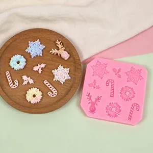 Close-up of a pink Christmas silicone mold and various finished colorful resin ornaments