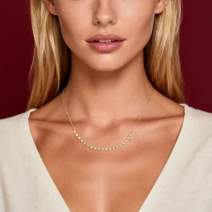 Elegant 14k gold moissanite smile necklace worn by a model against a red background