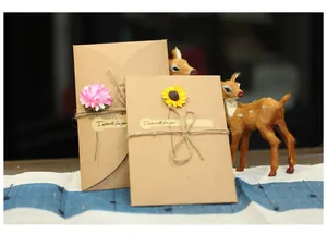 Detailed view of handmade kraft paper greeting cards with dried flowers and twine