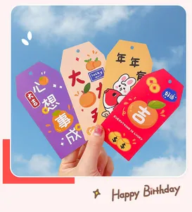 Close-up of colorful paper blessing tags with cute rabbit and orange illustrations.