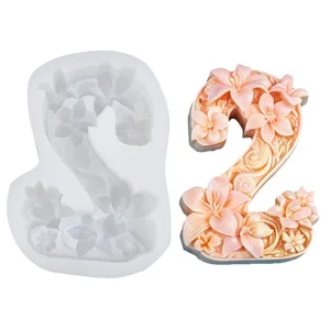 Detailed view of 3D number 2 floral relief silicone mold and finished pink floral candle