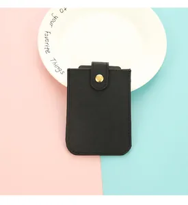 Close-up of black PU leather card holder with a gold-tone snap button closure