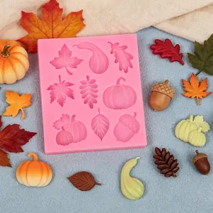 Detailed view of pink silicone harvest mold with molded leaf and pumpkin shapes