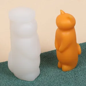 Comparison of a white DIY cat silicone mold and its orange finished candle ornament