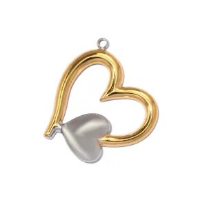 Close-up of a two-tone stainless steel heart pendant with gold and silver finishes.
