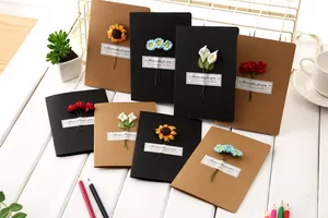 Detailed view of various vintage kraft greeting cards featuring handmade 3D dried flowers