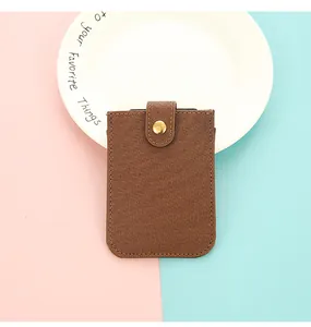 Detailed view of brown PU leather card holder with a secure vintage snap button closure