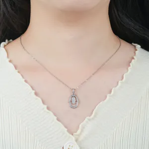 Close-up of sparkling Hamsa hand pendant necklace on a model's neck