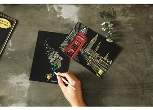 Close-up of DIY scratch art postcard set featuring a London night city scene detail.