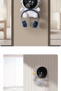 Creative astronaut wall-mounted organizer storing headphones and watches in a modern home