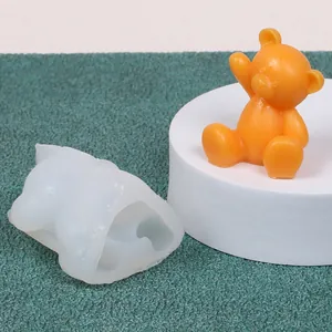 Detail view of animal silicone mold showing a cute finished orange bear figurine
