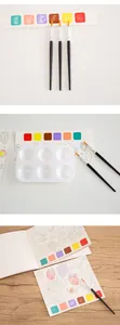 Detailed shot of children's watercolor set with paint strips, palette and brushes