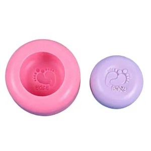 Close-up of circular pink silicone mold and embossed purple footprint-themed soap
