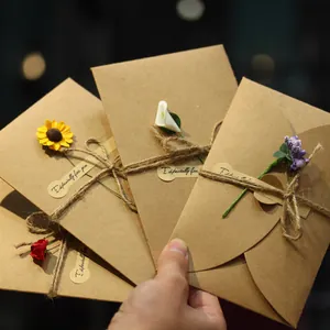 Handmade kraft paper greeting cards with dried flowers and twine for various festivals