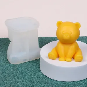Close-up view of translucent bear silicone mold and a finished yellow bear candle