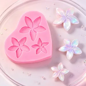 Detail view of pink silicone flower mold with finished iridescent resin flower charms