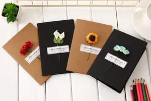 Creative retro kraft paper and black greeting cards with diverse handmade dried flower accents