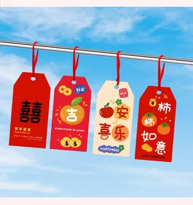 Detail of creative paper hangtags with Chinese characters hanging against a blue sky background.