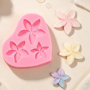 Detail of pink plumeria flower silicone mold with finished pastel resin samples