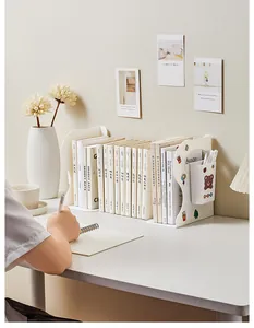 White adjustable desk bookend showing books and pens in a cozy home office setting