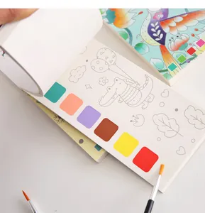 Close-up of portable watercolor coloring book with built-in paint squares and brush
