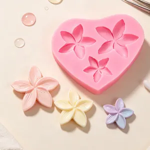Detailed view of pink heart-shaped silicone flower mold with finished resin floral crafts