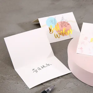 Elegant creative gold foil Best Wishes greeting cards with floral designs on desk