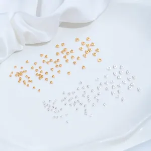 Detailed macro view of gold and silver triangle spacer beads for DIY jewelry making