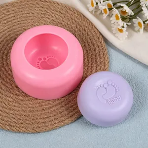 Detailed close-up of circular baby footprint silicone mold and finished purple soap