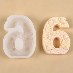 Detailed view of the floral relief number 6 silicone mold with a finished wax sample