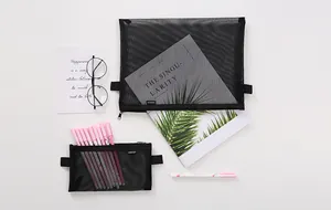 Detailed view of black mesh pencil cases with stationery props on a clean white background.
