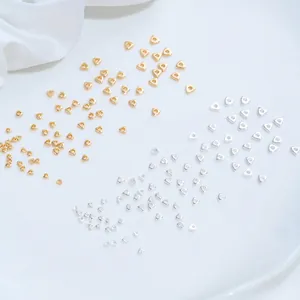 Macro view of tiny gold and silver triangle spacer beads for handmade DIY jewelry crafting