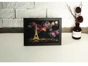 Framed colorful scratch art postcard of Eiffel Tower night view in home setting
