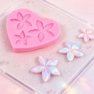 Close-up of pink heart-shaped silicone mold with iridescent flower crafts