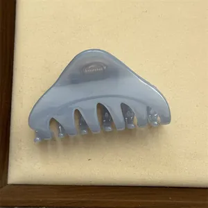Elegant triangular hair claw clip in muted blue-grey for half-up hairstyles.