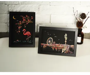 Scratch art postcards featuring colorful flamingo and city night view themes in frames