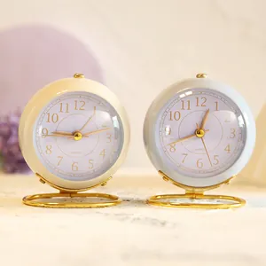 Pair of minimalist vintage mini desktop clocks in cream and blue with gold stands