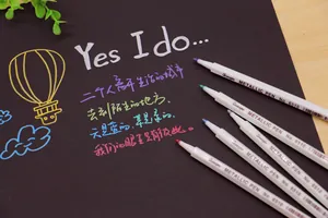 Multi-color metallic pens showing vibrant handwriting effect on black cardstock