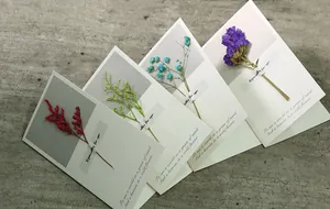 Set of four elegant greeting cards decorated with colorful real dried flowers.