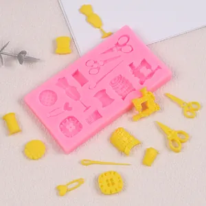Macro view of sewing theme silicone mold showing fondant scissors, buttons and spools