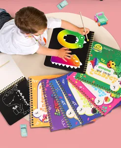 Close-up of a child using a colorful DIY scratch art spiral book with wooden pen.