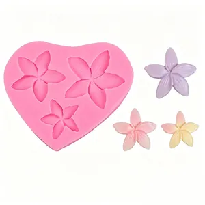 Pink heart-shaped silicone mold featuring small flower patterns for DIY resin crafts