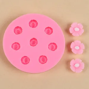 Detailed close-up of a pink cherry blossom silicone mold with finished resin flower samples